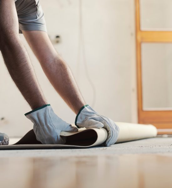 Contractor removing an old linoleum flooring