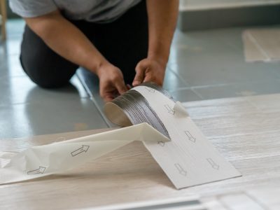 Installing vinyl flooring.