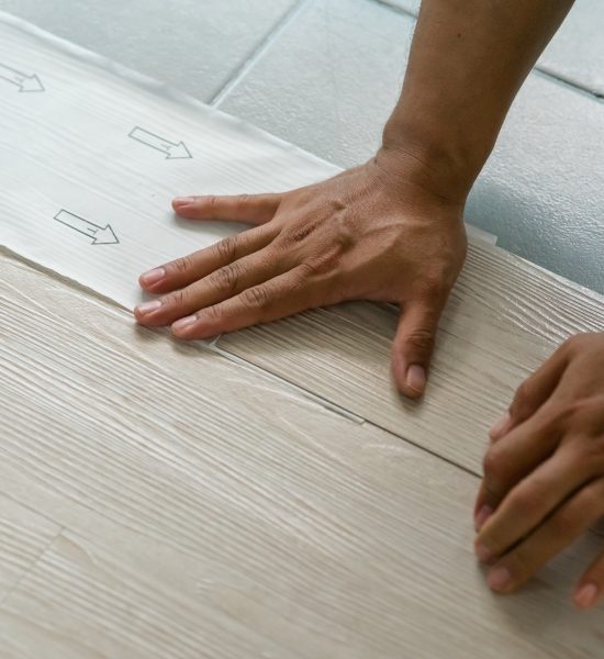 Vinyl floor installation, worker, DIY at home.